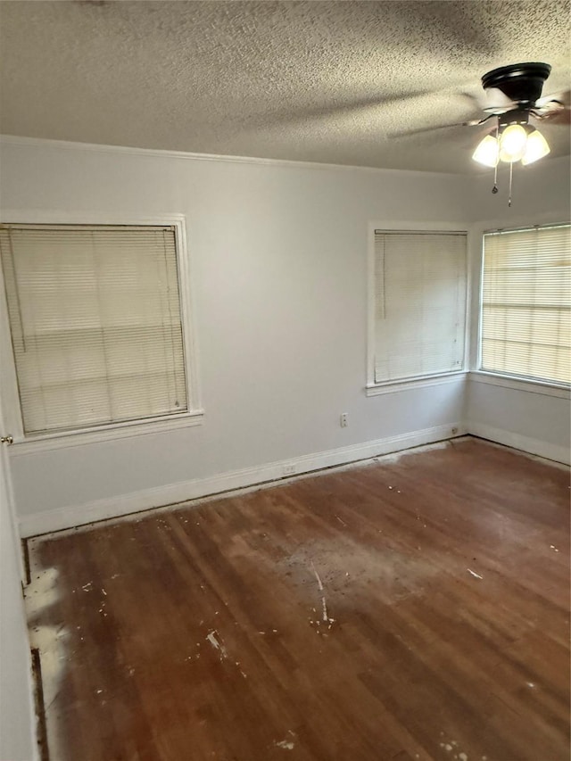 709 Highland Dr, Palestine, TX 75801 - empty room featuring wood finished floors, ceiling fan, and a textured ceiling