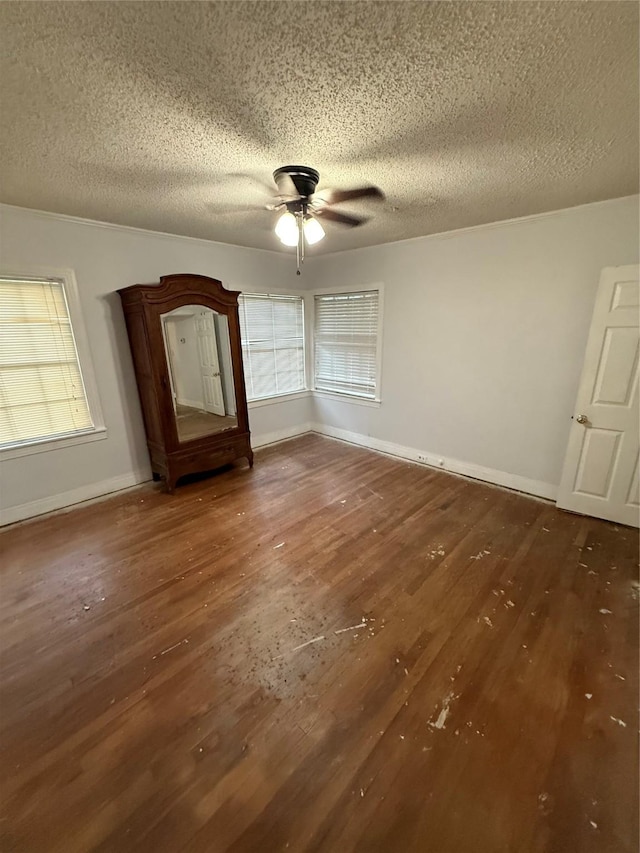 709 Highland Dr, Palestine, TX 75801 - empty room featuring a textured ceiling, ceiling fan, and hardwood / wood-style flooring