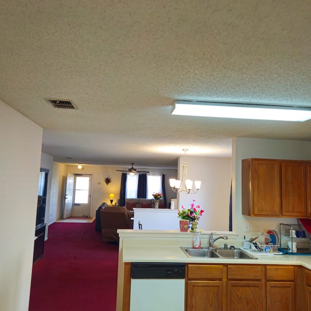1026 Mazourka Dr, Arlington, TX 76001 - kitchen with dishwasher, open floor plan, light countertops, a chandelier, and brown cabinets
