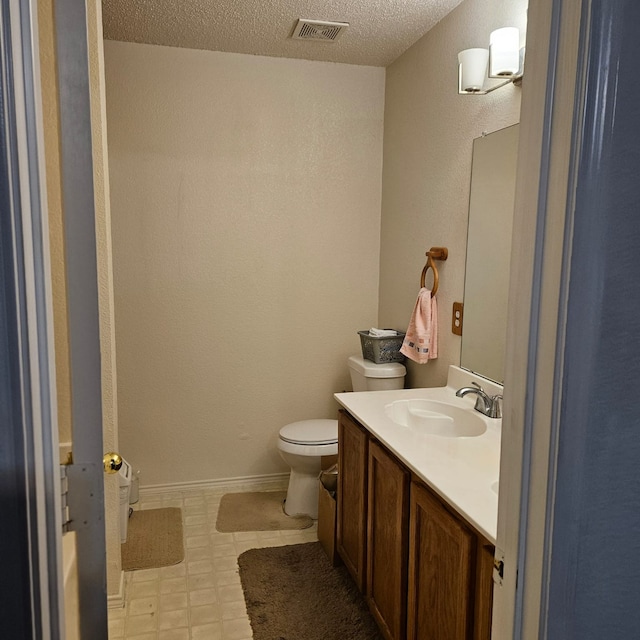 1026 Mazourka Dr, Arlington, TX 76001 - bathroom with tile patterned floors, a textured ceiling, and vanity