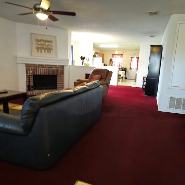 1026 Mazourka Dr, Arlington, TX 76001 - carpeted living room featuring a ceiling fan and a brick fireplace