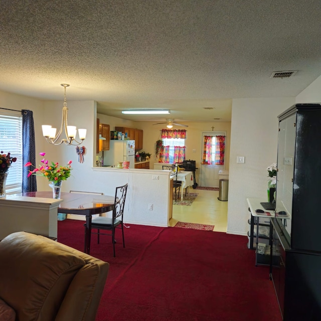 1026 Mazourka Dr, Arlington, TX 76001 - dining room with a textured ceiling, healthy amount of natural light, a chandelier, and carpet flooring