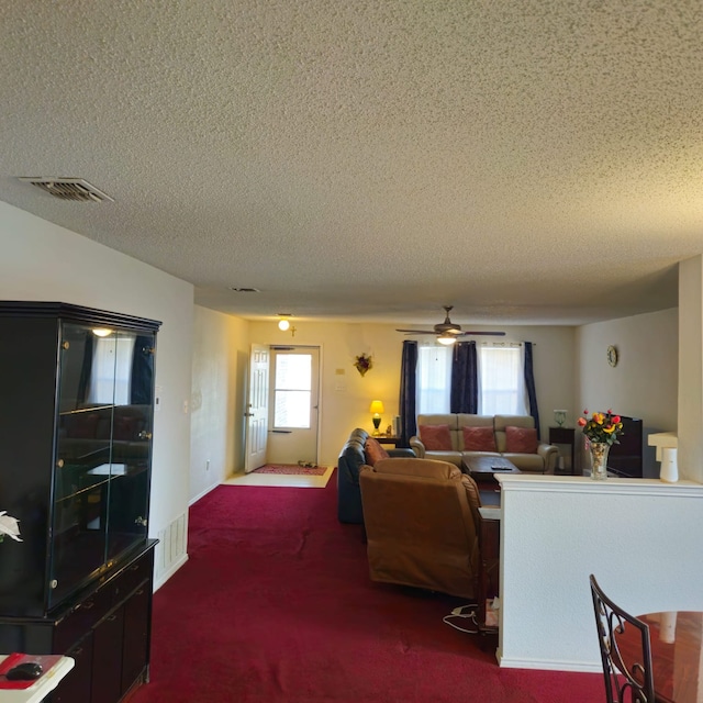 1026 Mazourka Dr, Arlington, TX 76001 - carpeted living room with a textured ceiling and a ceiling fan