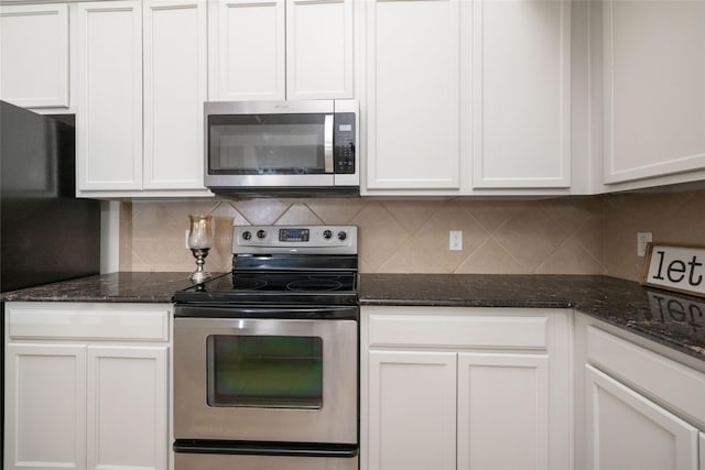 2401 Fawn Meadow Dr, Little Elm, TX 75068 - kitchen featuring stainless steel appliances, backsplash, dark stone countertops, and white cabinetry