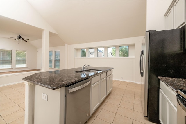 2401 Fawn Meadow Dr, Little Elm, TX 75068 - kitchen featuring dishwasher, light tile patterned flooring, vaulted ceiling, and dark stone counters