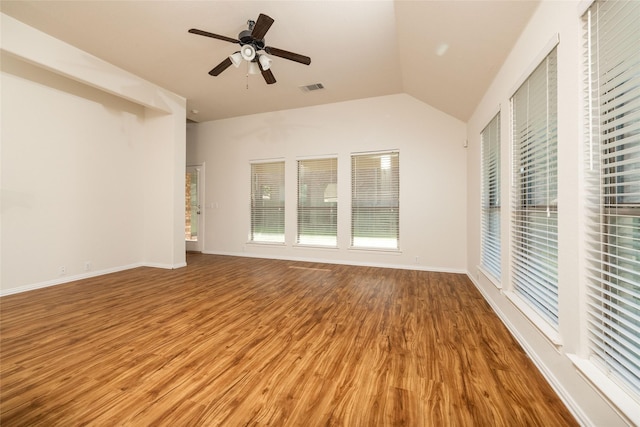 2401 Fawn Meadow Dr, Little Elm, TX 75068 - empty room with wood finished floors, vaulted ceiling, a ceiling fan, and healthy amount of natural light