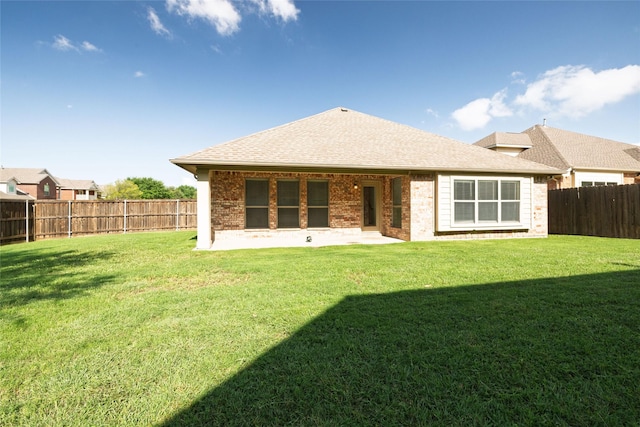 2401 Fawn Meadow Dr, Little Elm, TX 75068 - back of property with brick siding, a fenced backyard, and a shingled roof