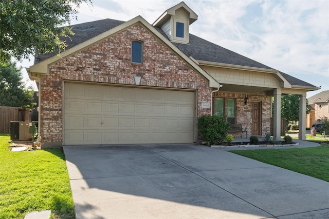 2401 Fawn Meadow Dr, Little Elm, TX 75068 - craftsman-style home with a porch, brick siding, concrete driveway, an attached garage, and a shingled roof
