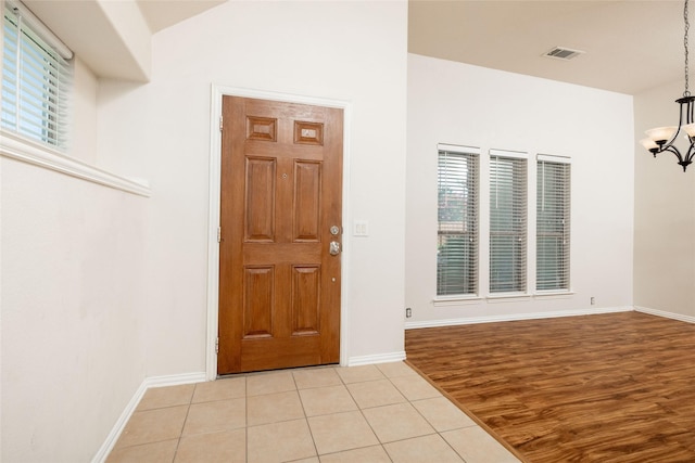 2401 Fawn Meadow Dr, Little Elm, TX 75068 - foyer with a chandelier and light tile patterned floors