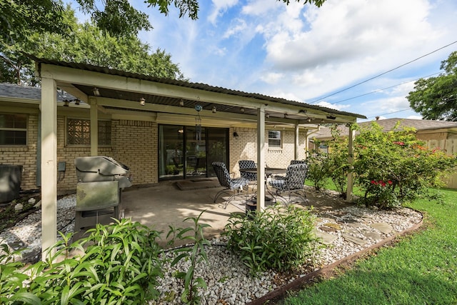 13835 Pyramid Dr, Farmers Branch, TX 75234 - back of property featuring brick siding and a patio