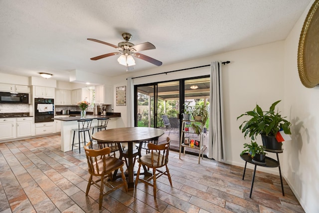 13835 Pyramid Dr, Farmers Branch, TX 75234 - dining space with a ceiling fan and a textured ceiling