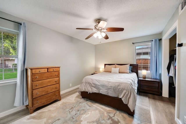 13835 Pyramid Dr, Farmers Branch, TX 75234 - bedroom with wood finished floors, a ceiling fan, and a textured ceiling