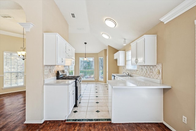 5219 Tennis Villa Dr, Arlington, TX 76017 - kitchen featuring gas range, light wood-style flooring, white cabinetry, light countertops, and lofted ceiling