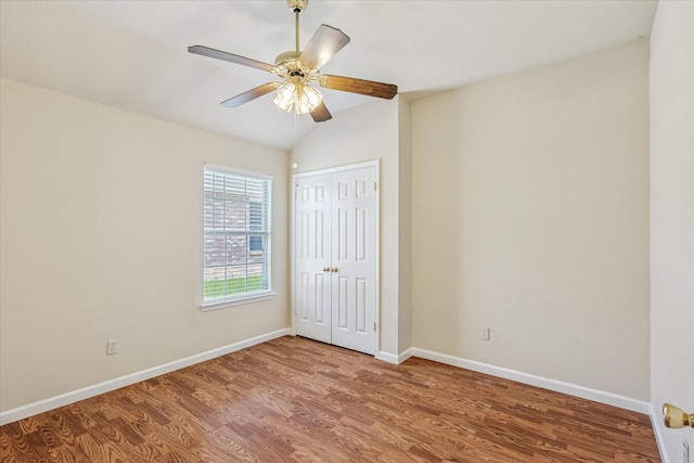 5219 Tennis Villa Dr, Arlington, TX 76017 - unfurnished bedroom featuring wood finished floors, a closet, lofted ceiling, and a ceiling fan