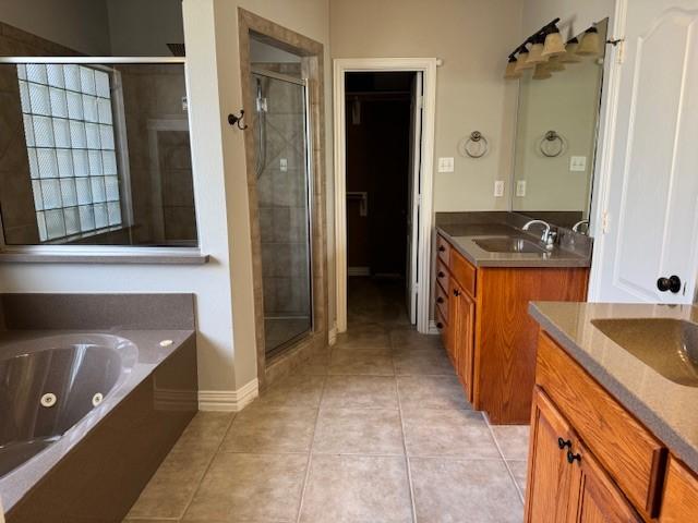 3840 W Pioneer Dr, Irving, TX 75061 - full bath with a stall shower, two vanities, tile patterned flooring, and a whirlpool tub
