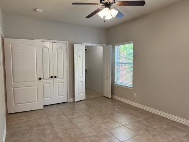 3840 W Pioneer Dr, Irving, TX 75061 - unfurnished bedroom with light tile patterned flooring, a ceiling fan, and a closet