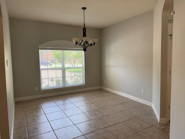 3840 W Pioneer Dr, Irving, TX 75061 - unfurnished room featuring tile patterned floors, a chandelier, and arched walkways