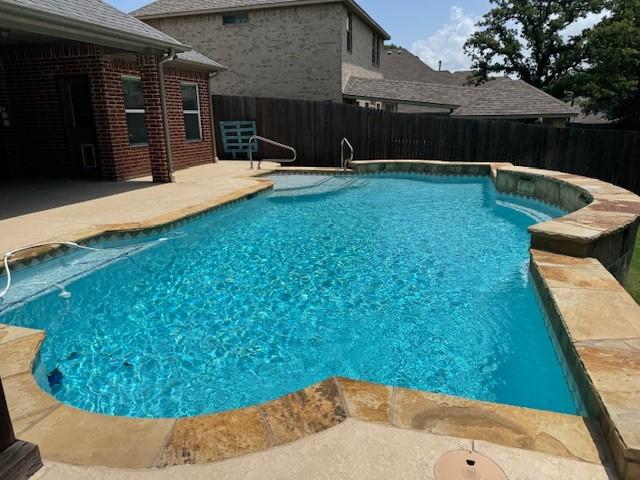 3840 W Pioneer Dr, Irving, TX 75061 - view of swimming pool with a fenced backyard and a patio area