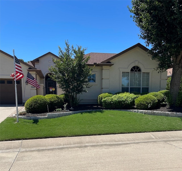 9009 Gardenia Dr, Denton, TX 76207 - view of front facade featuring a front yard, a garage, stucco siding, and concrete driveway