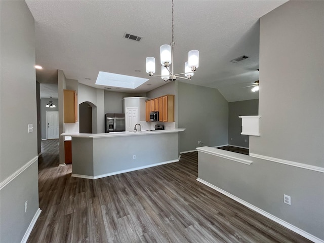 4400 Ripplewood Rd, Frisco, TX 75035 - kitchen featuring appliances with stainless steel finishes, open floor plan, ceiling fan, a chandelier, and dark wood-style flooring