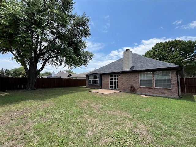 4400 Ripplewood Rd, Frisco, TX 75035 - rear view of property with brick siding, a fenced backyard, a patio area, a chimney, and roof with shingles