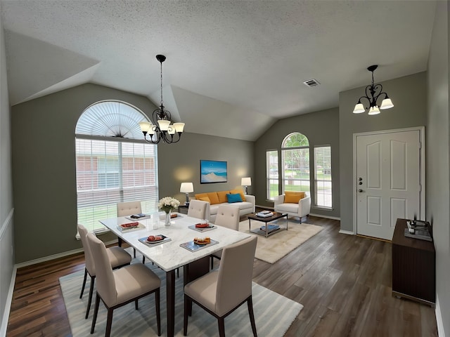 4400 Ripplewood Rd, Frisco, TX 75035 - dining area with a chandelier, vaulted ceiling, dark wood-style flooring, and a textured ceiling