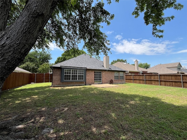 4400 Ripplewood Rd, Frisco, TX 75035 - back of property featuring a chimney, a fenced backyard, brick siding, and a patio area