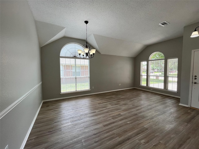 4400 Ripplewood Rd, Frisco, TX 75035 - spare room featuring vaulted ceiling, a chandelier, dark wood-style floors, and a textured ceiling
