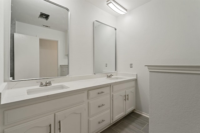 2024 Oakmeadow St, Bedford, TX 76021 - bathroom with double vanity and a textured wall