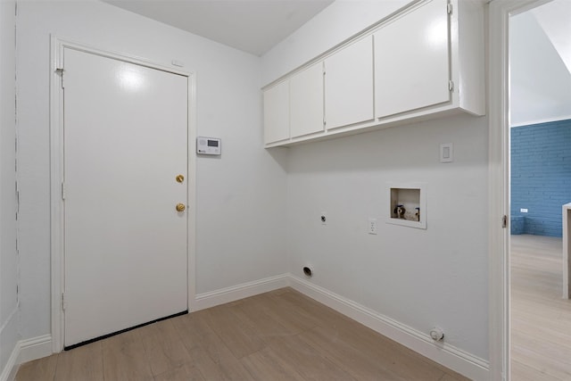 2024 Oakmeadow St, Bedford, TX 76021 - washroom featuring cabinet space, washer hookup, light wood-style flooring, hookup for an electric dryer, and gas dryer hookup