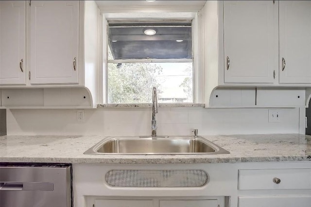 3501 NE 10th St, Mineral Wells, TX 76067 - kitchen featuring stainless steel dishwasher, white cabinetry, and backsplash