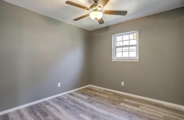 3501 NE 10th St, Mineral Wells, TX 76067 - empty room with wood finished floors, ceiling fan, and a textured ceiling