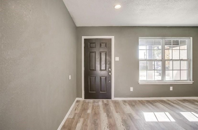 3501 NE 10th St, Mineral Wells, TX 76067 - entrance foyer with wood finished floors and a textured ceiling