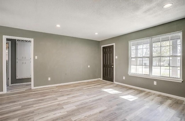 3501 NE 10th St, Mineral Wells, TX 76067 - foyer entrance featuring a textured ceiling, light wood-style floors, and recessed lighting