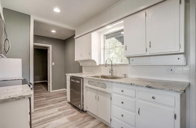 3501 NE 10th St, Mineral Wells, TX 76067 - kitchen with dishwasher, white cabinets, light wood-type flooring, recessed lighting, and light stone countertops