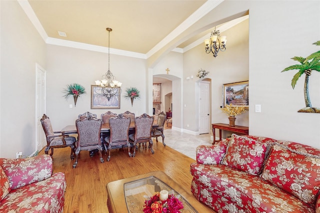 5768 Gallant Run, Frisco, TX 75033 - living area with a chandelier, arched walkways, ornamental molding, and wood finished floors