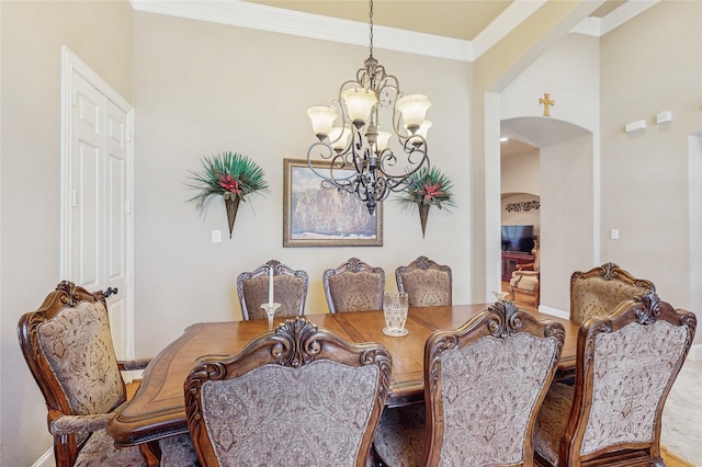 5768 Gallant Run, Frisco, TX 75033 - dining space featuring a chandelier, arched walkways, and crown molding