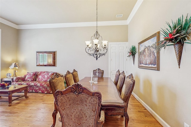 5768 Gallant Run, Frisco, TX 75033 - dining space with a chandelier, light wood-type flooring, and crown molding