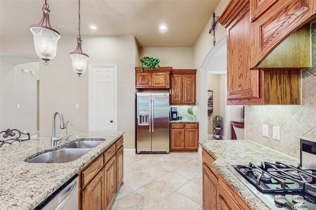 5768 Gallant Run, Frisco, TX 75033 - kitchen featuring appliances with stainless steel finishes, arched walkways, backsplash, light stone counters, and hanging light fixtures