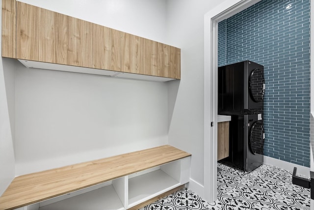 4603 Newmore Ave, Dallas, TX 75209 - mudroom featuring stacked washer and clothes dryer and baseboards