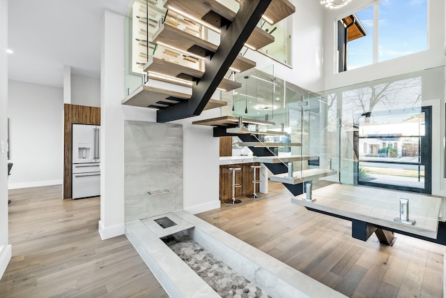 4603 Newmore Ave, Dallas, TX 75209 - stairs featuring wood finished floors and a towering ceiling