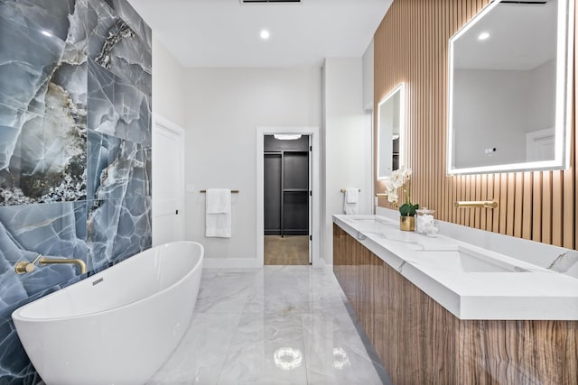 4603 Newmore Ave, Dallas, TX 75209 - full bath with marble tiled flooring, a freestanding tub, and double vanity