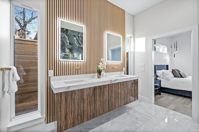 4603 Newmore Ave, Dallas, TX 75209 - ensuite bathroom with double vanity, healthy amount of natural light, and marble finish floors