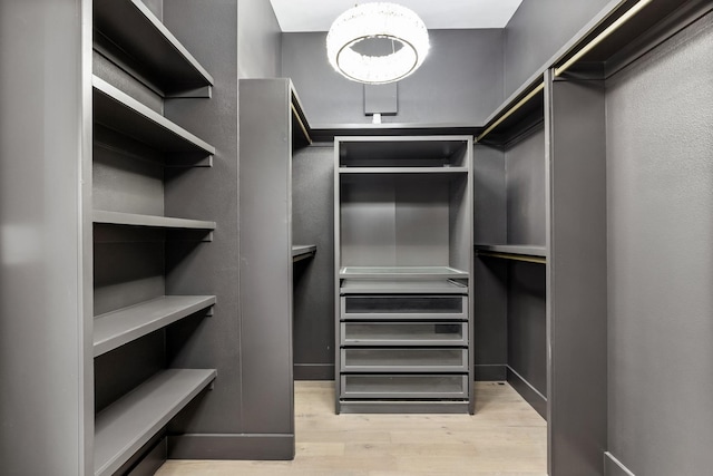 4603 Newmore Ave, Dallas, TX 75209 - spacious closet with wood finished floors and a chandelier