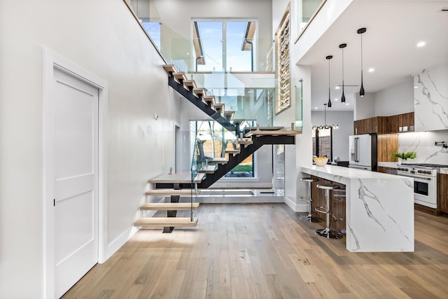 4603 Newmore Ave, Dallas, TX 75209 - stairs with a high ceiling, wood finished floors, and healthy amount of natural light