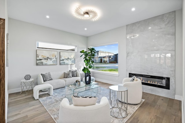 4603 Newmore Ave, Dallas, TX 75209 - living area featuring a premium fireplace, wood finished floors, and recessed lighting