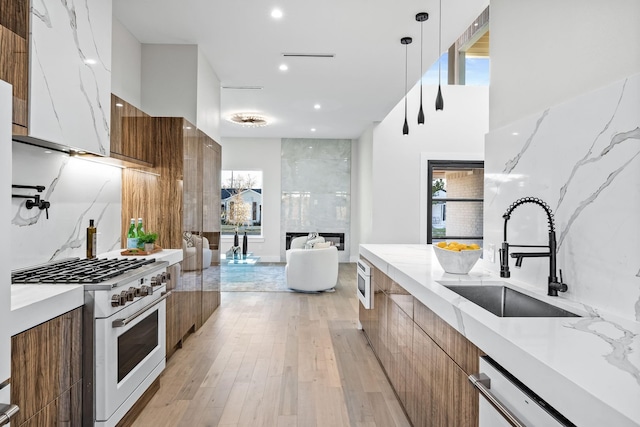 4603 Newmore Ave, Dallas, TX 75209 - kitchen with modern cabinets, high end white range, brown cabinetry, dishwasher, and light wood-type flooring