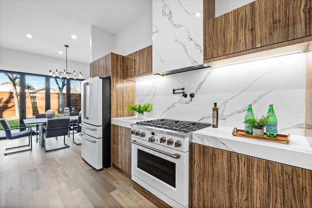 4603 Newmore Ave, Dallas, TX 75209 - kitchen with white appliances, modern cabinets, brown cabinetry, light wood-type flooring, and recessed lighting