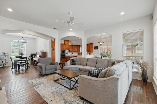 1128 Bent Oaks Dr, Denton, TX 76210 - living room featuring arched walkways, a ceiling fan, wood finished floors, recessed lighting, and a chandelier