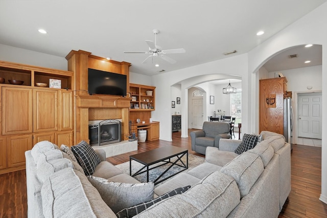 1128 Bent Oaks Dr, Denton, TX 76210 - living area with arched walkways, ceiling fan, dark wood finished floors, a tiled fireplace, and recessed lighting